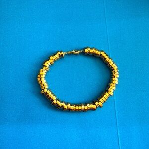 Gold tone gold disc bracelet by Maa Designs